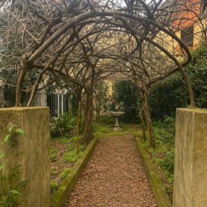 Arco vegetale e fontana nel giardino segreto di una villa pisana.