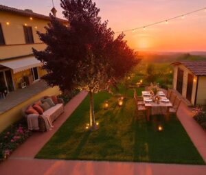 Giardino pomeridiano sereno con albero illuminato, patio terracotta e tavola romantica.