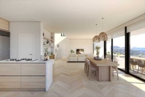 Moderna zona giorno open space con cucina di design, zona pranzo e vista panoramica.
