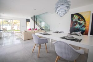 Soggiorno e sala da pranzo moderni, open space luminoso con arredamento minimalista e opere darte.