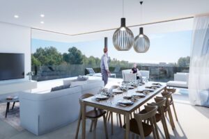 Salone moderno con tavolo da pranzo e vista panoramica sulla foresta e sul mare.