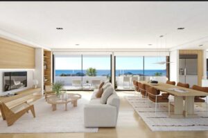 Soggiorno moderno open space con arredi di design, terrazza e vista sul mare.