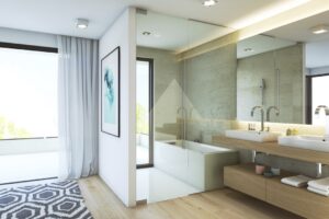 Bagno moderno e luminoso con doppio lavabo, doccia in vetro e affaccio sul terrazzo.